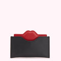 Black leather card holder with a red lip detail.