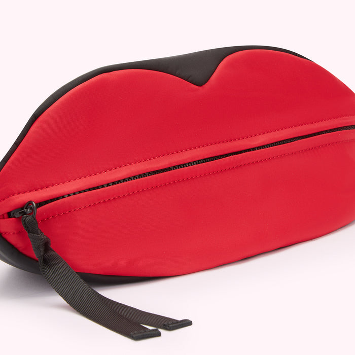 Red and black lip-shaped zippered belt bag.