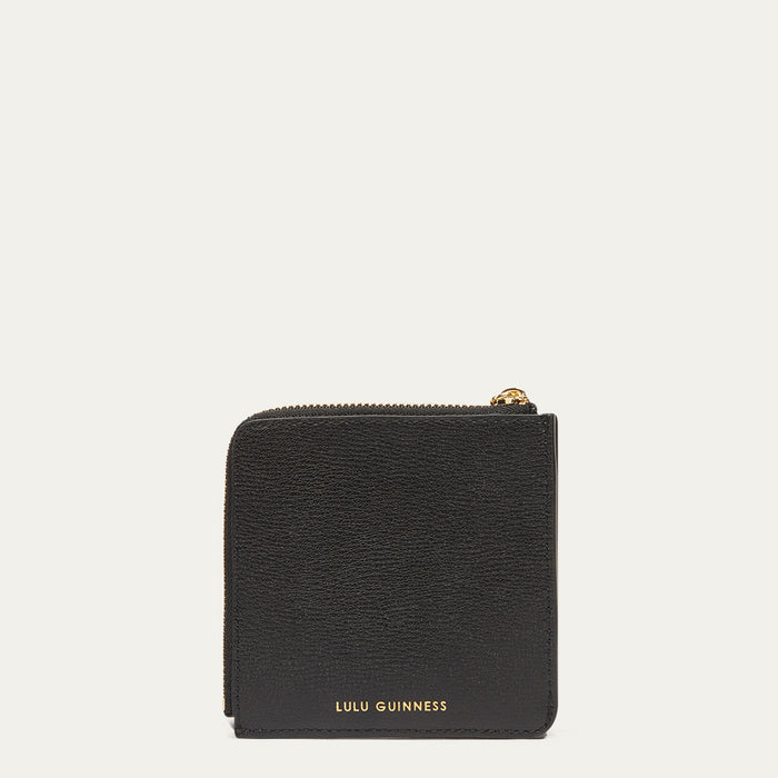 Black wallet with gold zipper and 'Lulu Guinness' branding on a white background