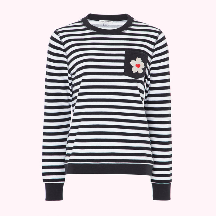 Black and white striped long-sleeved top with a small flower detail on the pocket.