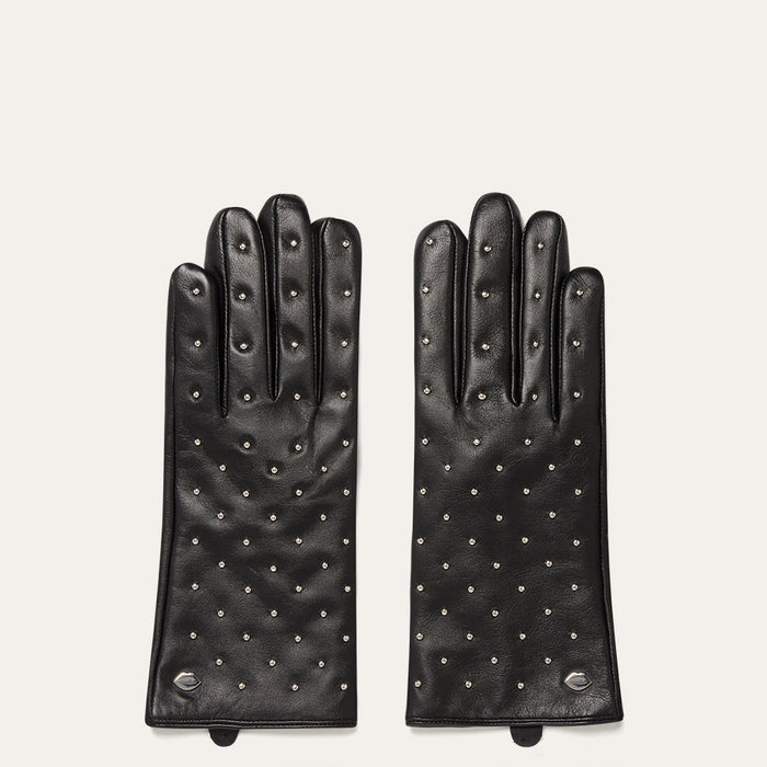 Pair of black leather gloves with studded details on a light gray background