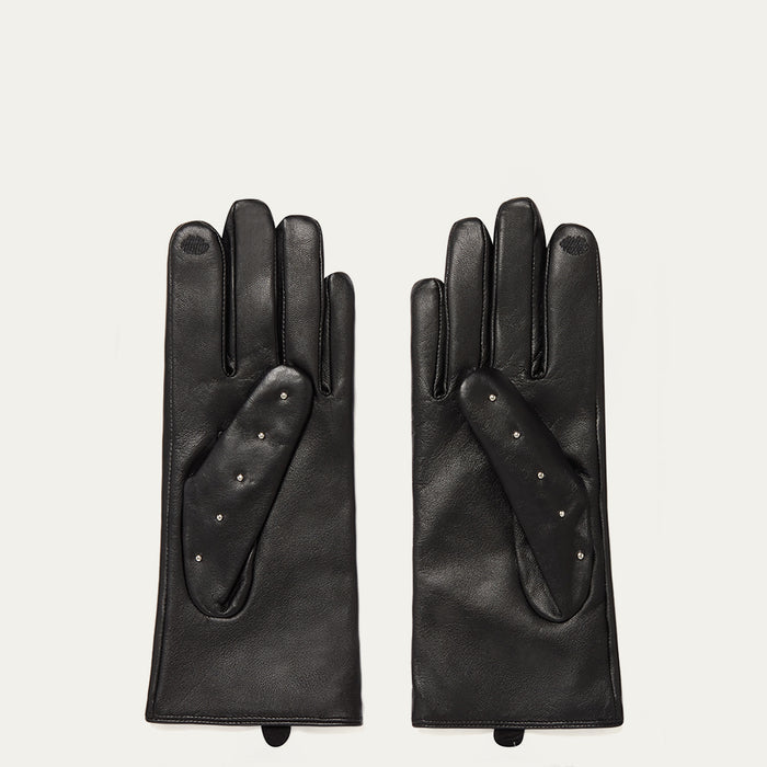 Pair of black leather gloves on a light gray background