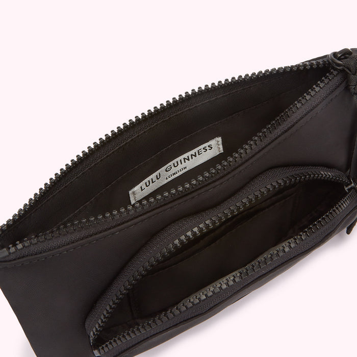 Open black Lulu Guinness London zipper pouch with multiple compartments.