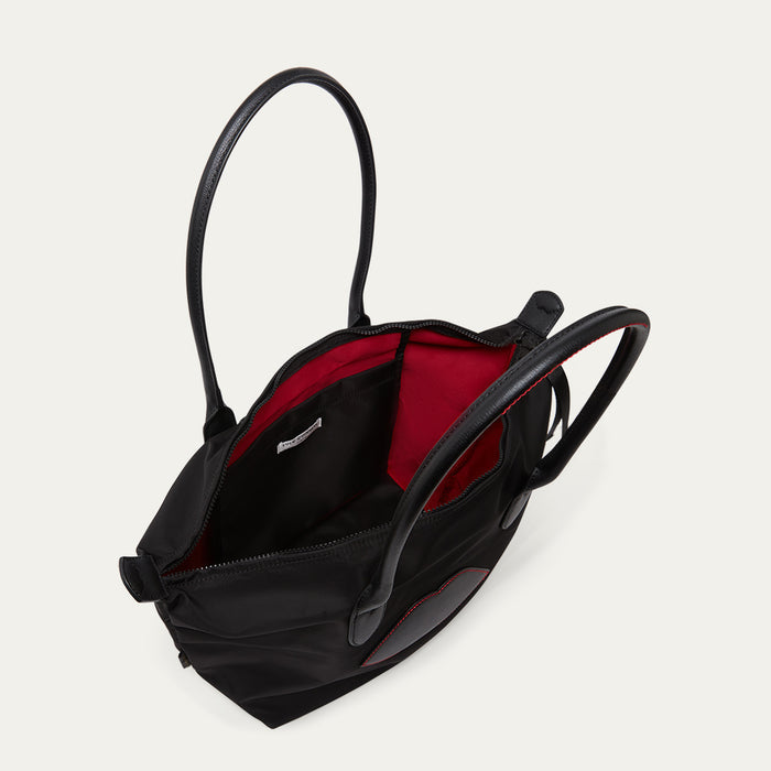 Black bag with lip detail open to reveal the inside pocket on a light grey background
