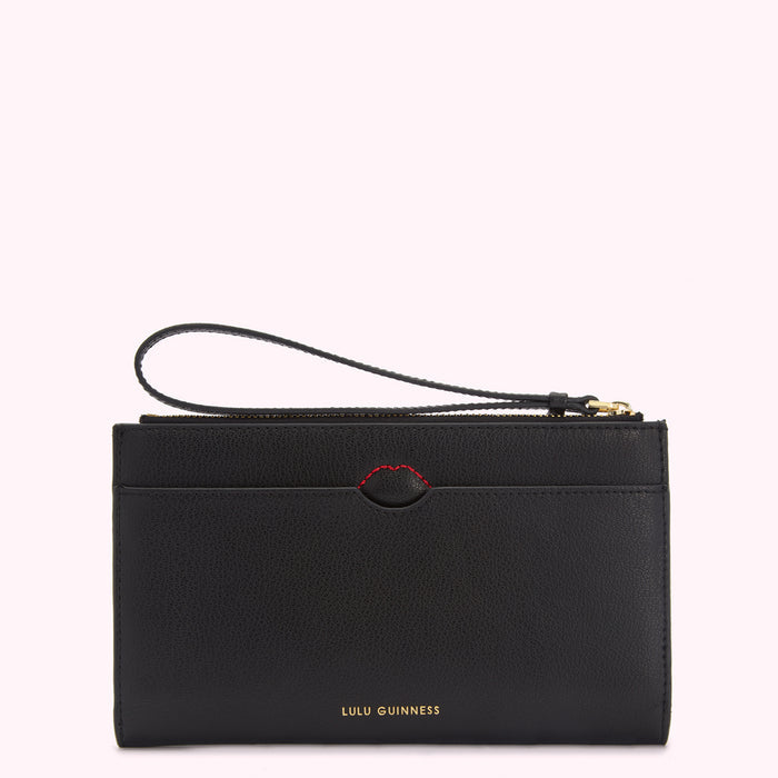 Black Lulu Guinness purse with a wrist strap and a small red heart detail.
