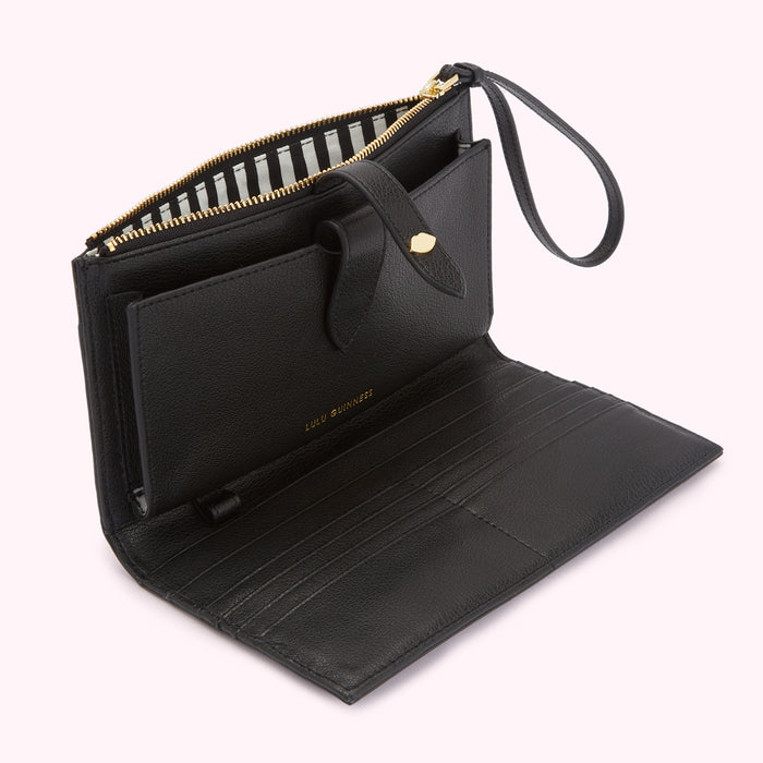 Open black Lulu Guinness leather wallet with gold zipper and clasp. The interior lining is black and white striped.