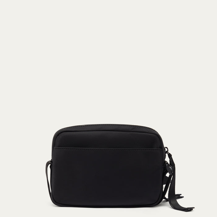 Black crossbody bag on a light grey background