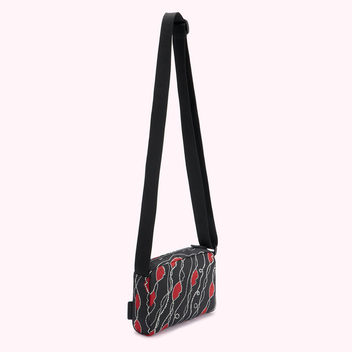 Black crossbody bag with red and white patterned design.