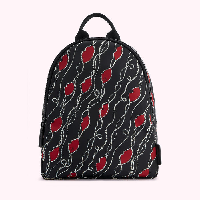 Black backpack with red lips and white pearls pattern.