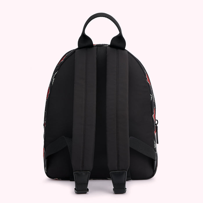 Black backpack with red and white patterned sides, viewed from the back.
