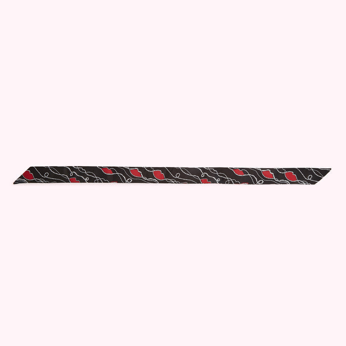 Black scarf with a pattern of red lips and white dots.