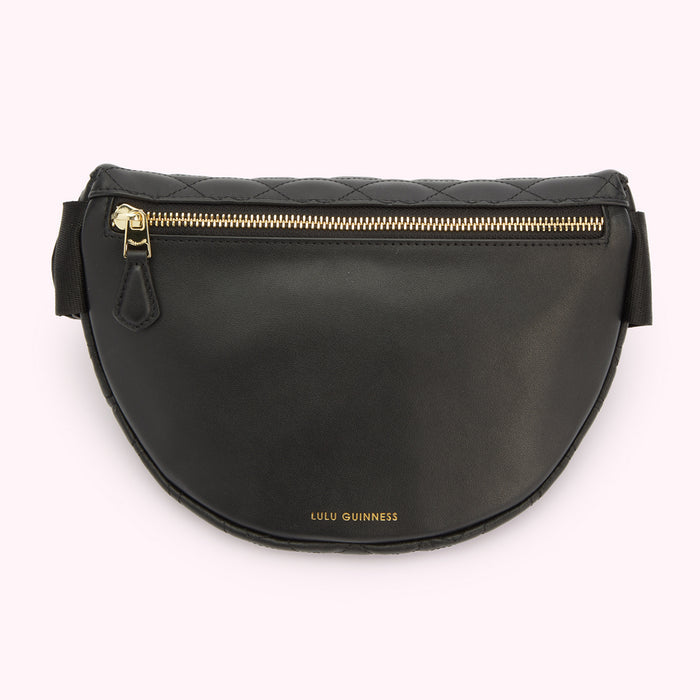 A back image of a black leather belt bag showing a hidden zipped pocket and a gold foil print Lulu Guinness logo.