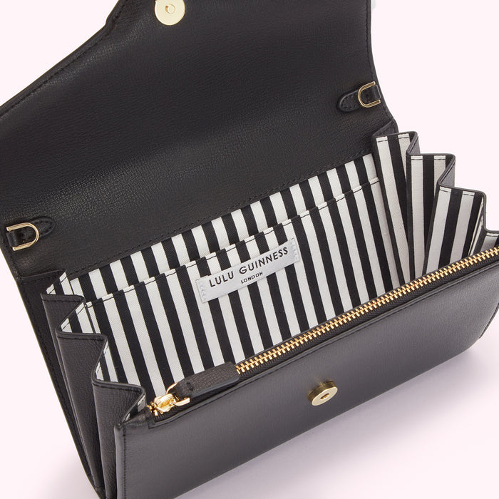 Open black Lulu Guinness London wallet with black and white striped interior.