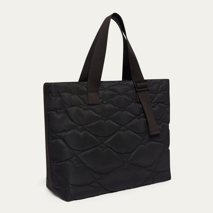 Black quilted tote bag with woven straps on a white background