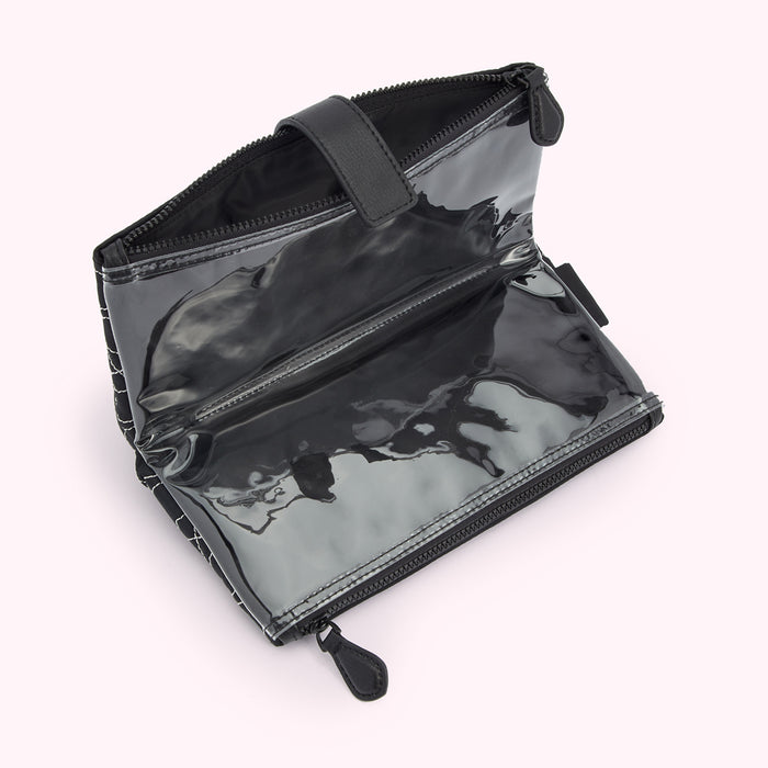 Black quilted makeup bag with clear PVC front and black leather pull.