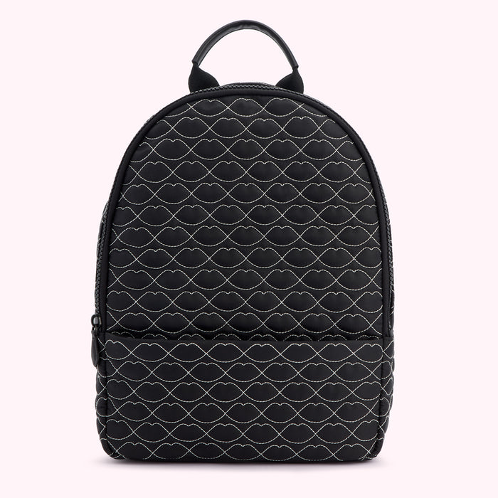 Black quilted backpack with a repeating lip print.