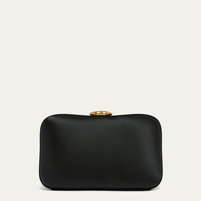 Black satin clutch bag with a gold lip clasp on a light gray background