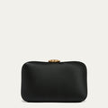 Black satin clutch bag with a gold lip clasp on a light gray background
