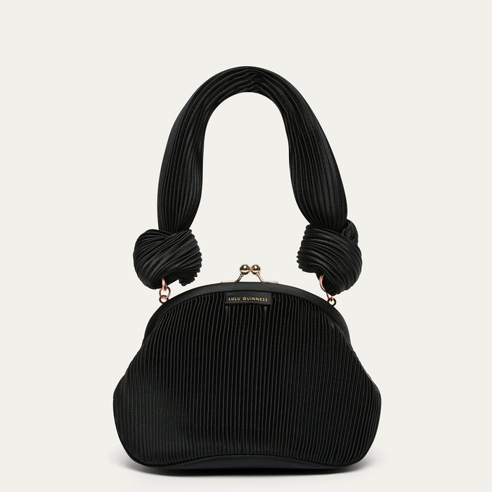 Black pleated satin handbag with knotted handles on a light gray background