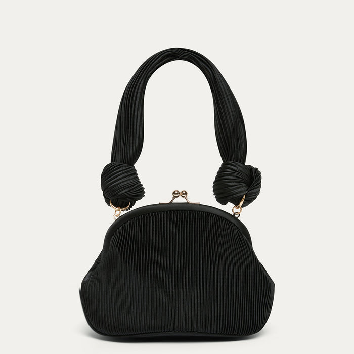Black pleated satin handbag with knotted handles on a light gray background