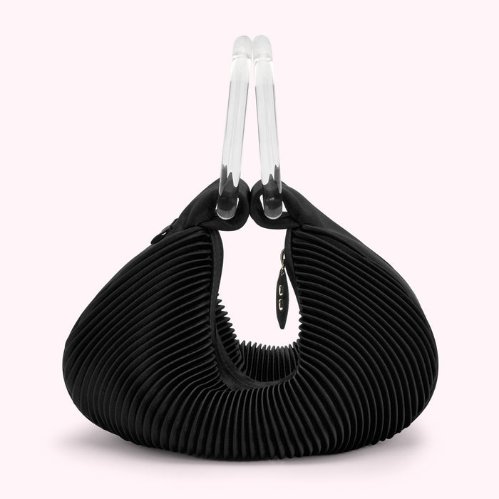 Black pleated handbag with clear acrylic handles.