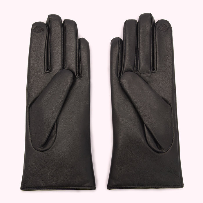 Pair of black leather gloves on a white background.