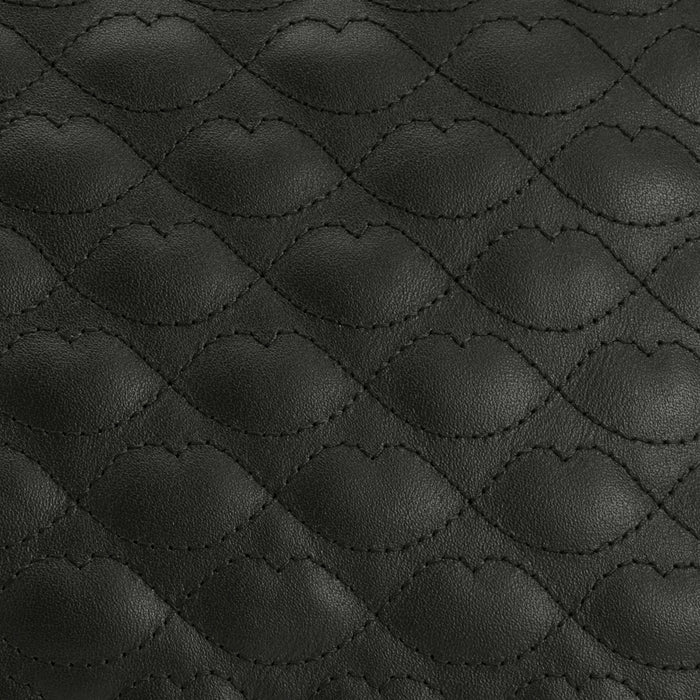 Close-up of black quilted leather with a repeating diamond pattern.