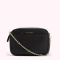 Black Lulu Guinness crossbody bag with gold chain strap.