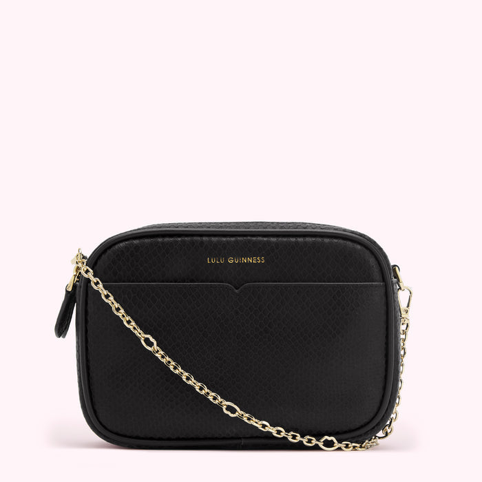 Black Lulu Guinness crossbody bag with gold chain strap.