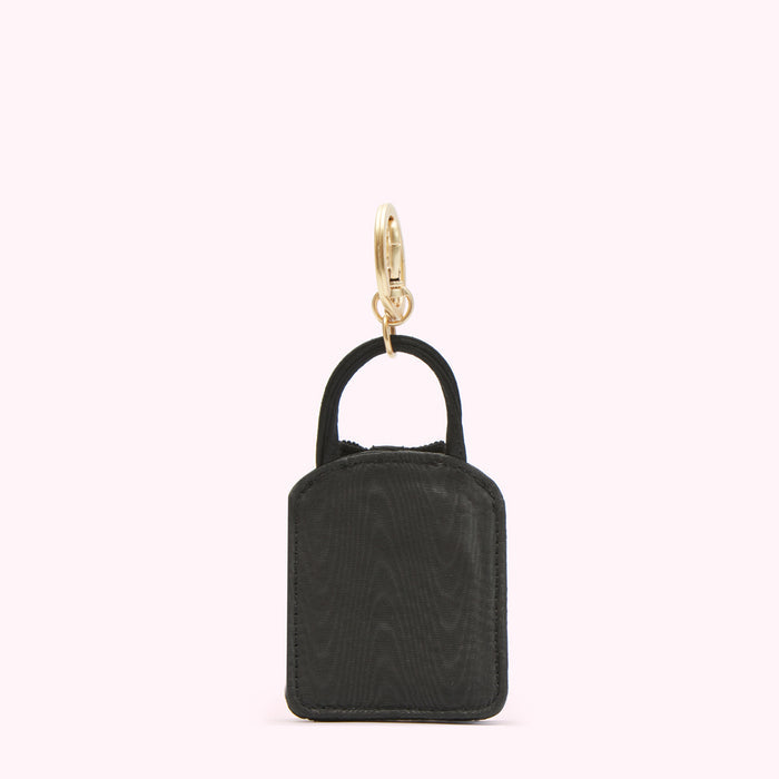 Black handbag-shaped keychain with gold clasp.