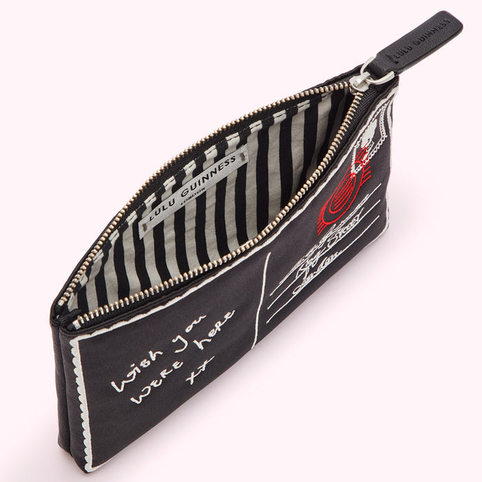 Black Lulu Guinness postcard-print zip pouch open to reveal black and white striped lining.