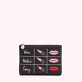 Black makeup bag with embroidered lipsticks and lips, categorized for work, weekend and evening.