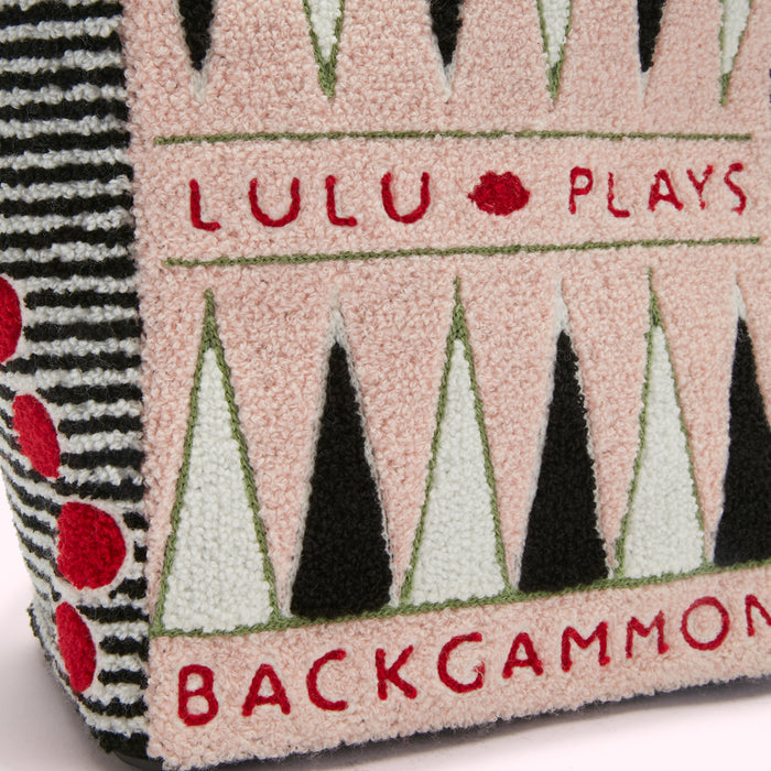 Close-up of a pink and black embroidered tote bag with the words "Lulu Plays Backgammon".