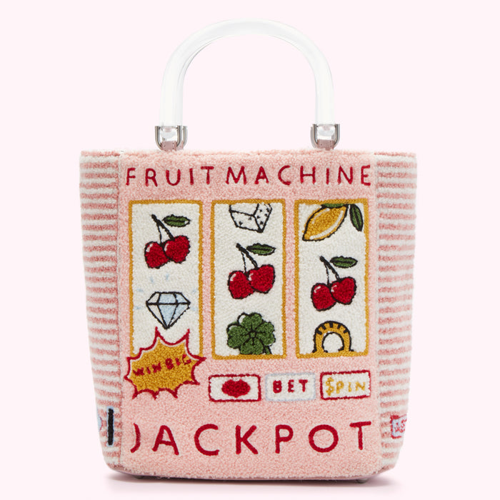 Pink tote bag with a fruit machine design and clear handle. The bag has embroidered cherries, diamonds, and other fruit machine symbols. The text "Fruit Machine" and "Jackpot" are also embroidered on the bag.