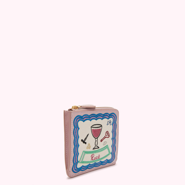Pink leather purse with embroidered rose-themed design.