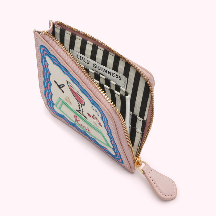 Pink Lulu Guinness zip-around purse with embroidered rose illustration; open to reveal black and white striped interior.