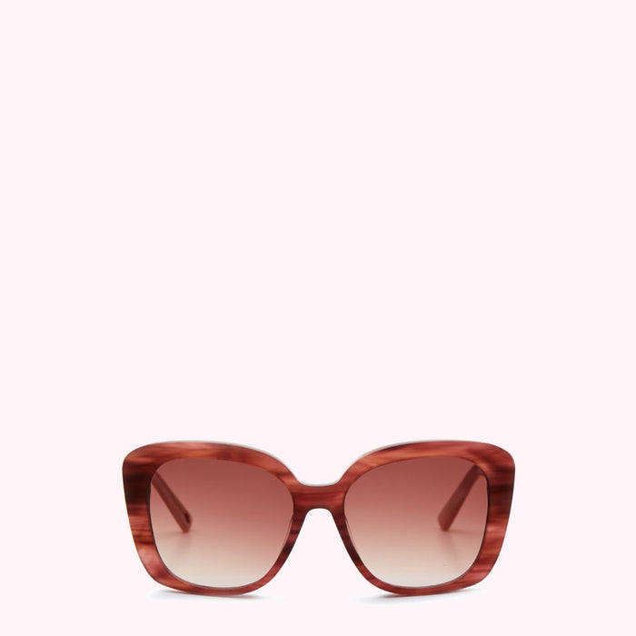 Brown and pink sunglasses with a gradient brown lens against a white background.