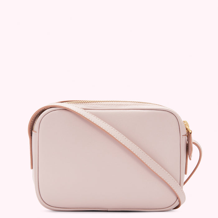 Pale pink leather crossbody bag with gold zipper.