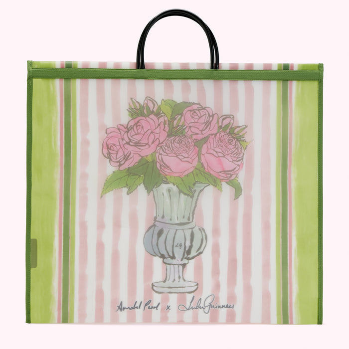 Large green and pink striped tote bag with a drawing of pink roses in a vase. The bag has black handles and the text "Annabel Pearl x Lulu Guinness" is printed on the bottom.