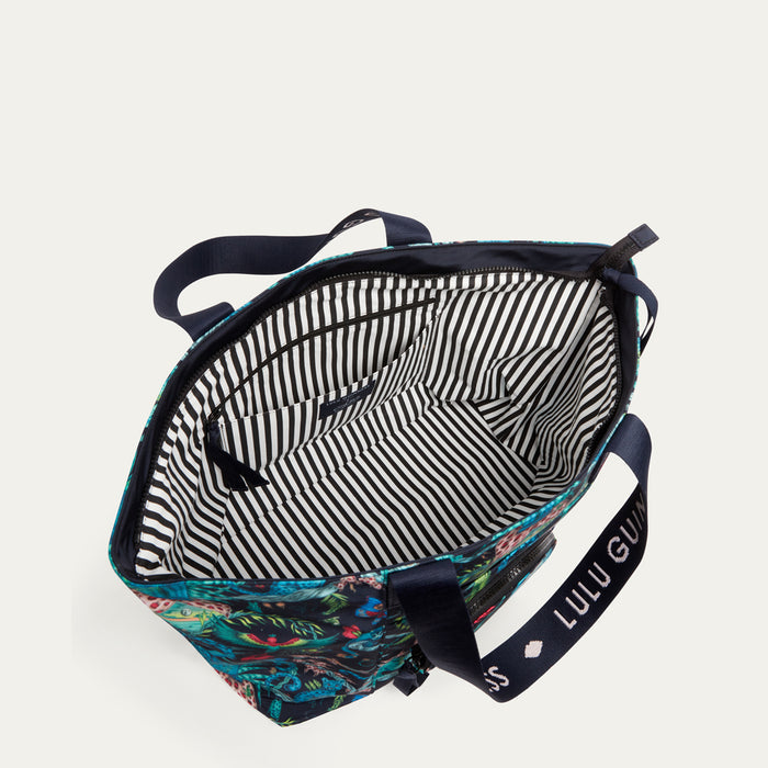 Multicolored bag with floral pattern and striped interior on a white background
