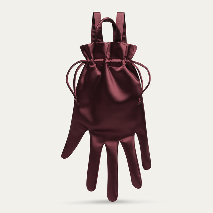 Maroon satin hand-shaped backpack with a drawstring on a light gray background