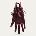 Maroon satin hand-shaped backpack with a drawstring on a light gray background