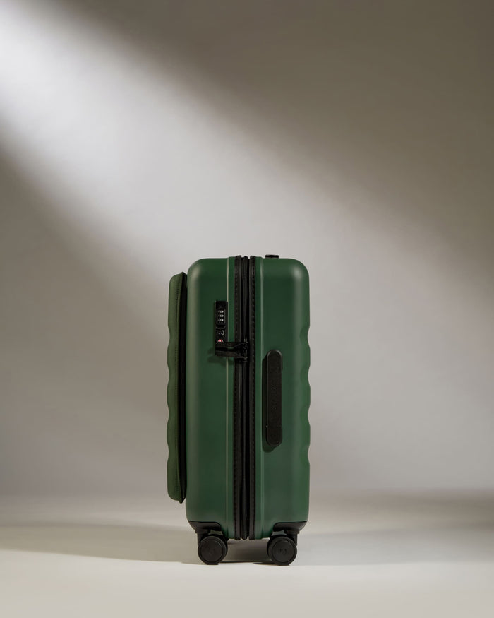 a green suitcase with wheels