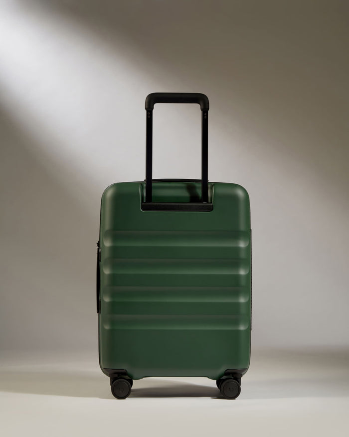 a green suitcase with a handle