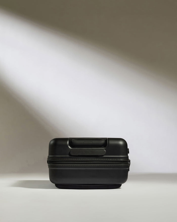 a black suitcase with light shining on it