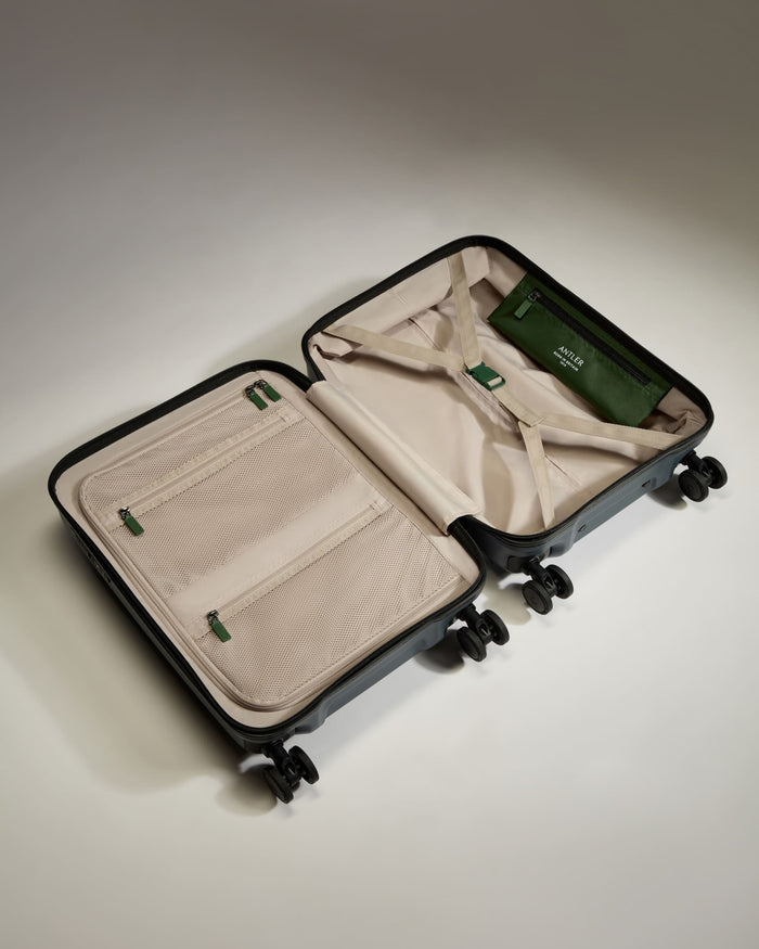 a suitcase with wheels and a green tag