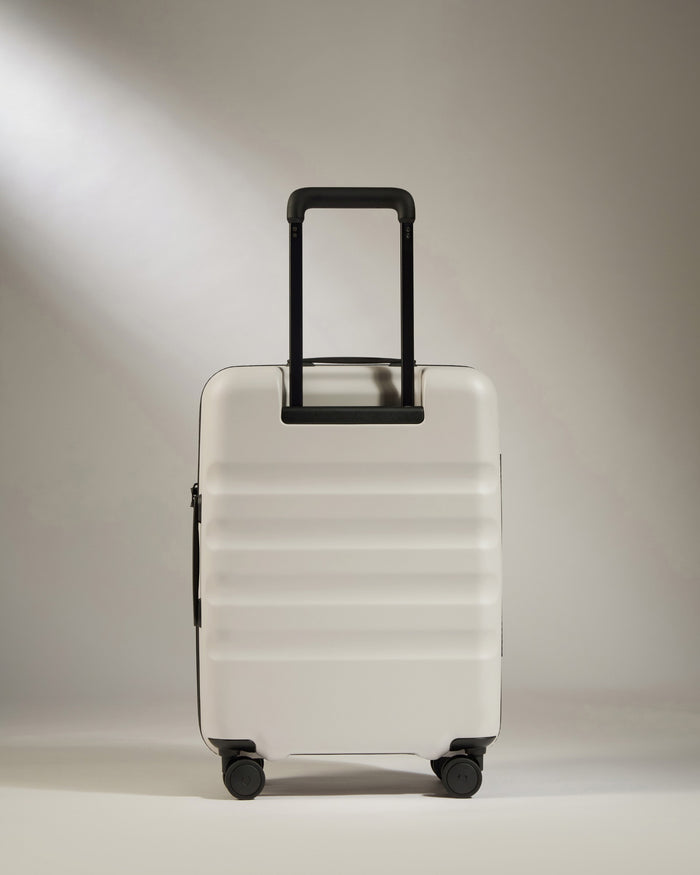 a white suitcase with black handle