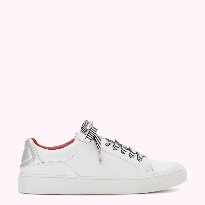White leather low-top sneaker with black and white striped laces and a red leather accent.