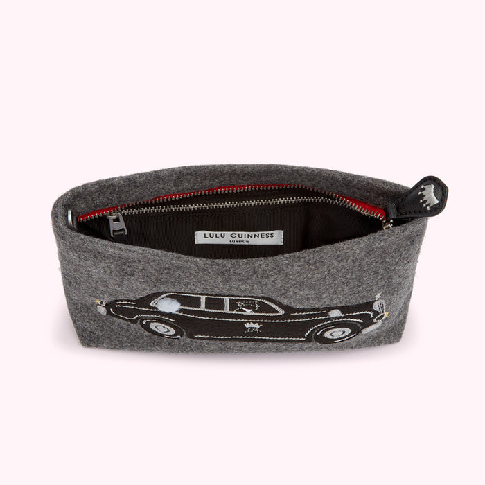 Grey felt clutch with embroidered car and red zipper. Lulu Guinness label visible inside.