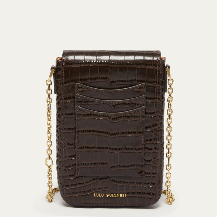 A dark brown croc effect embossed leather crossbody bag with gold chain straps and gold-tone hardware, featuring the LULU GUINNESS brand name on the front, set against a plain light background.